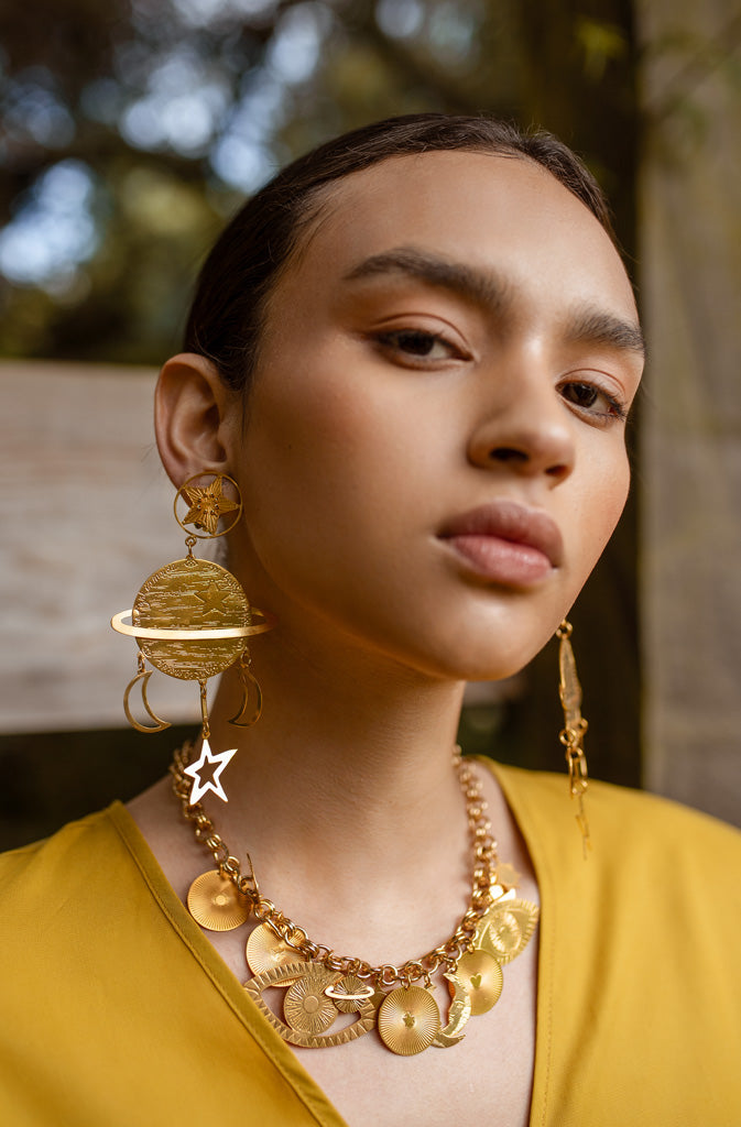 Lucky Saturn EarringsEarringsExtra large clip-on earrings in the shape of Saturn, the planet that symbolises wisdom and discipline spiritually. Additional pendants in the shape of moons and starGlobalistinaLucky Saturn EarringsGlobalistina